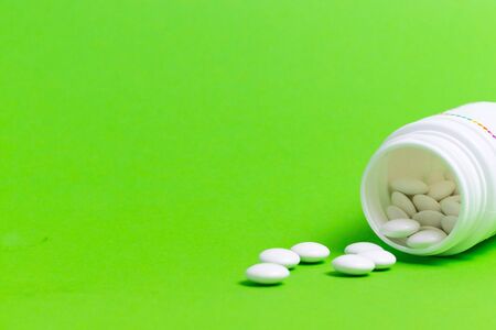 Tablets for the treatment of bacteria and viruses on a greenの写真素材