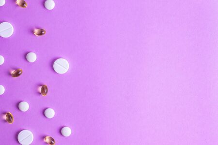 Pills on the background from different diseases human therapy on a purple backgroundの写真素材
