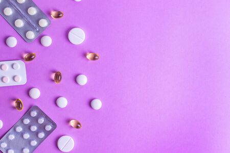 Pills on the background from different diseases human therapy on a purple backgroundの写真素材