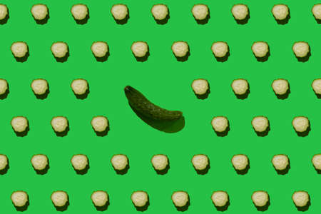 Pattern of Bulgarian sweet peppers, cherry tomatoes and cucumbers on a green backgroundの写真素材