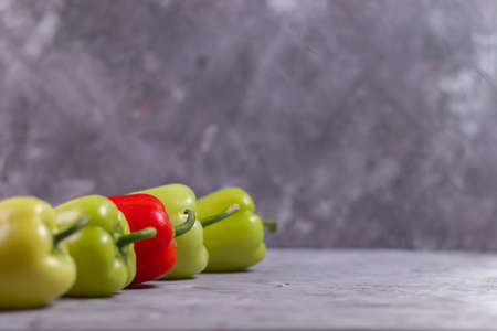 Green and red peppers perspective view on gray concrete background copyspaceの写真素材