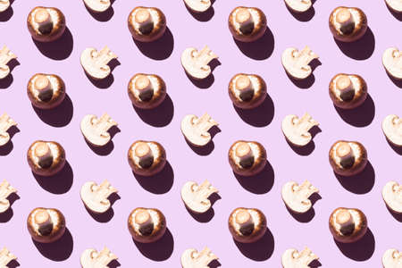 Seamless pattern of cut and whole champignons on a purple backgroundの写真素材