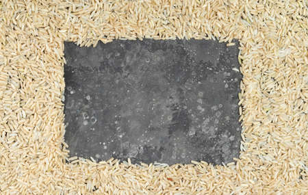 Brown raw rice frame on gray backgroundの写真素材