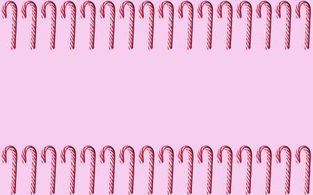 Frame of red and white Christmas candy staffs on a pink background