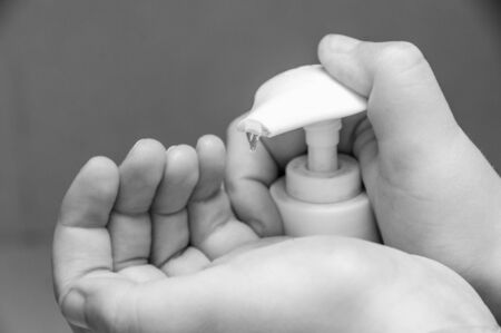 About to wash his hands with an antiseptic gelの写真素材