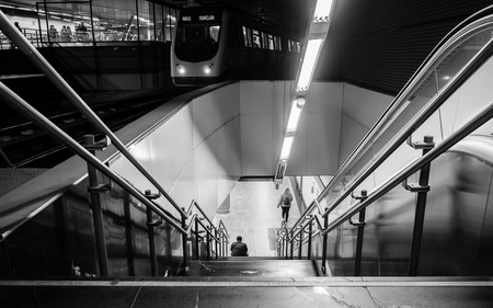 Train in a metro station in Madrid with stairs,escalators and peopleのeditorial素材