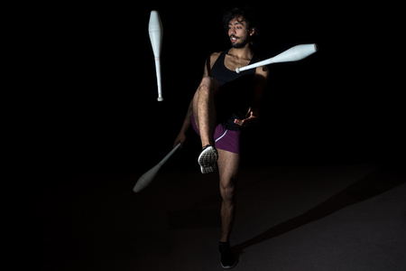 Young juggler making a performance at the circusの写真素材