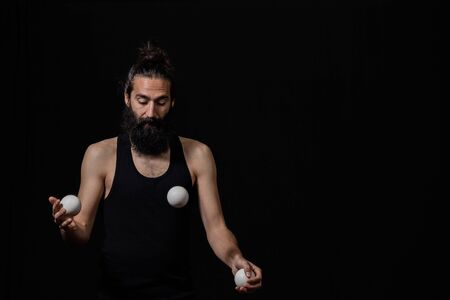 Man fully focused on his juggling performance at the circus. Mindfulness / concentration concept.の写真素材