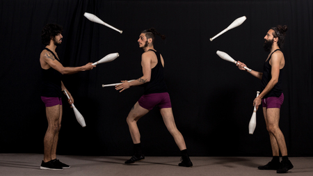 Circus jugglers during their batons show. Teamwork conceptの写真素材