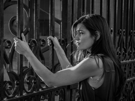 Beautiful woman claiming freedom (captive / fear / anger concept)の写真素材