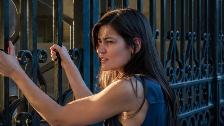 Beautiful woman claiming freedom (captive / fear / anger concept)の写真素材