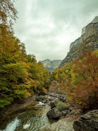 Cloudy canyon in autumn in Ordesa National Park (Pyrenees, Spain)の写真素材