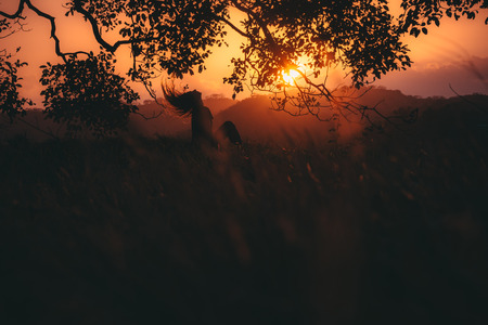 Silhouette of Girl on the hill with the sunset
