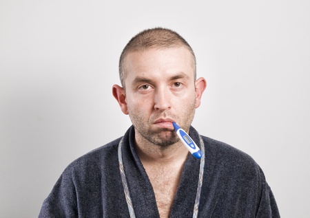 Sick man with thermometer on white background rA normal man, no model の写真素材