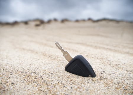 Car key lost in the sand on the beachの写真素材