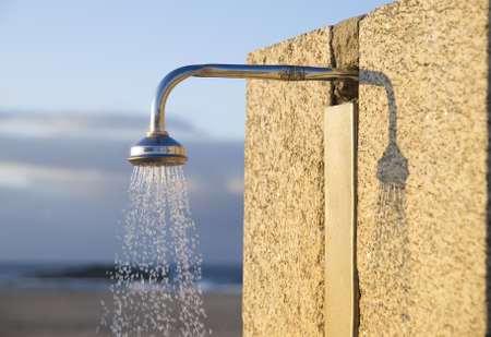 Detail of a water shower on the beach in horizontal compositionの写真素材