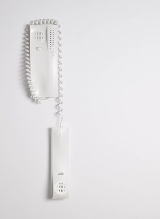 Intercom off hook on a white wallの写真素材