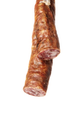 Iberian spanish sausage hanging on white backgroundの写真素材