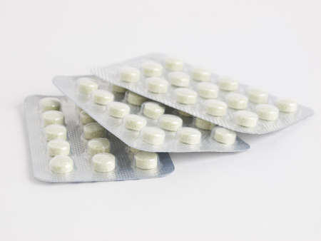 Three pills tablets on white backgrond