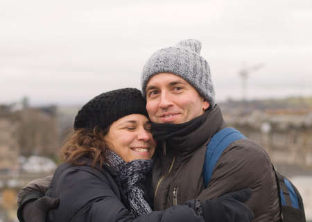 Man and woman embracing in a cold dayの写真素材