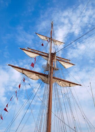 Mast of a ship with furled sails の写真素材