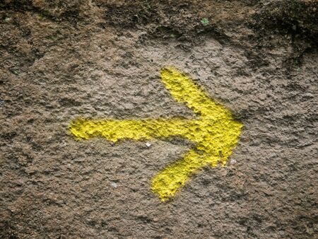 Arrow painted on a wall and pointing to the rightの写真素材