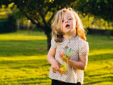 Little blond girl with funny expression