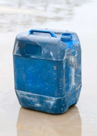 Blue plastic drum outdoors. Drum is used.