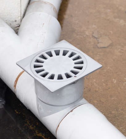 Plastic drain in a work outdoors in a square composition
