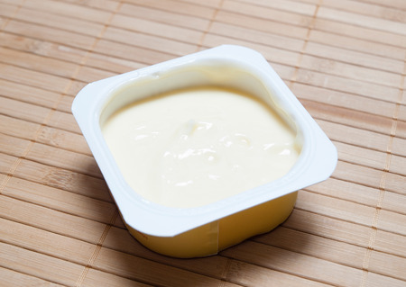  Vanilla custard in a plastic container on bamboo backgroundの写真素材
