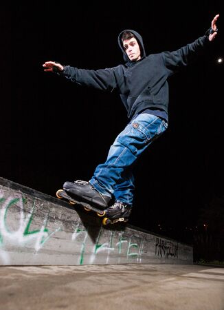 Young man practicing rollerskating. The young is grind a curb.のeditorial素材