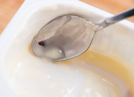 Scrape remnants of custard in a studio shotの写真素材