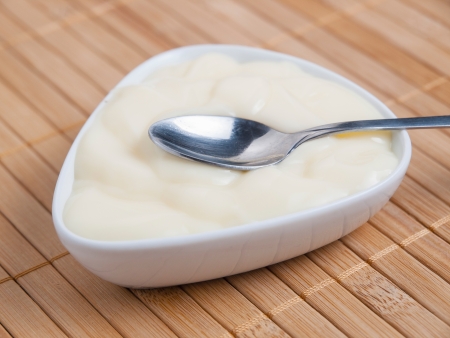 Spoon with custard detail in a studio shotの写真素材
