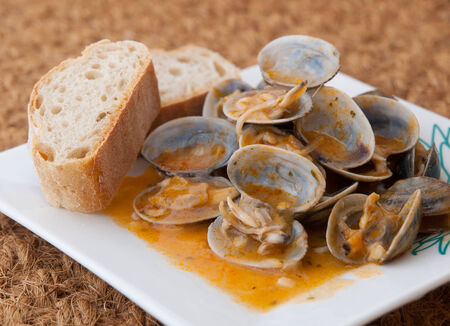 Clams cooked in the recipe "almejas a la marinera" in a studio shotの写真素材