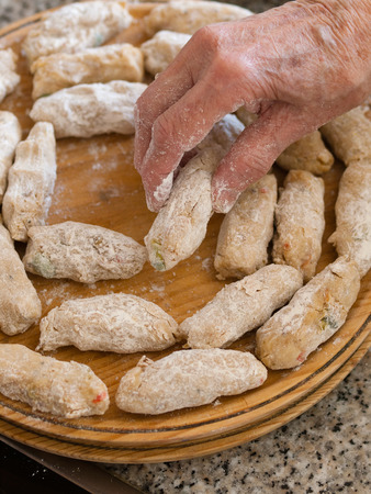 Preparing a homemade croquettes. The croquettes are being prepared by a grandmother.の写真素材