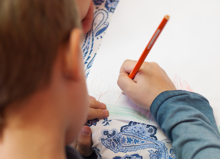 Little boy drawing at the school
