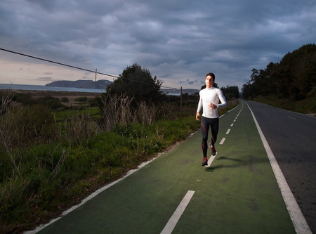 Runner man portrait with flash light outdoorsの写真素材