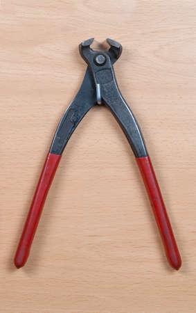 Tong isolated on wooden backgroundの写真素材