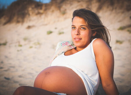 Pregnant woman on the beach outdoorsの写真素材