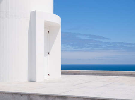 White door and the sea beyond  in Ortegal cape, Galicia, Spain.の写真素材