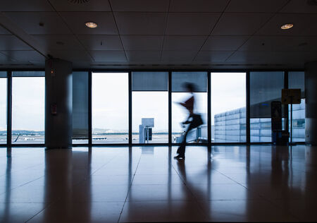 Person in motion in an airport in horizontal compositionのeditorial素材