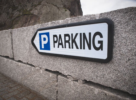 Parking sign in a stone wall outdoors