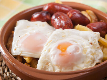 Eggs with french fries and small sausages. A typical spanish dish.の写真素材