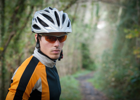 Cyclist portrait in a path of the forest