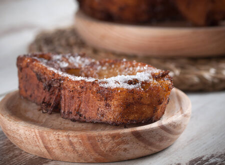 French toasts on a wooden plate. A delicious meal.