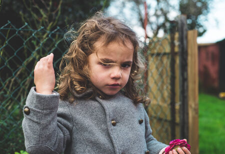 Small girl with wild hair in the wind.の写真素材