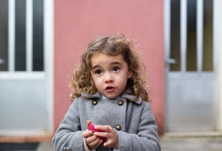 Little girl portrait outdoors. The little girl is talkingの写真素材
