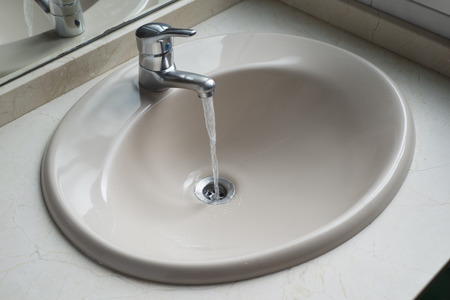 working water tap in a bathroom. Bathroom detail.の写真素材