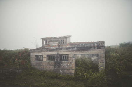 Old ruins in the field in a foggy dayの写真素材
