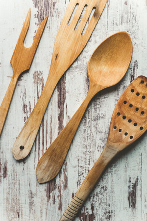 Kitchen utensils made of wood on a wooden backgroundの写真素材